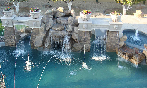 Gunite swimming pool with lazy river, grotto, scuppers and sheer descents