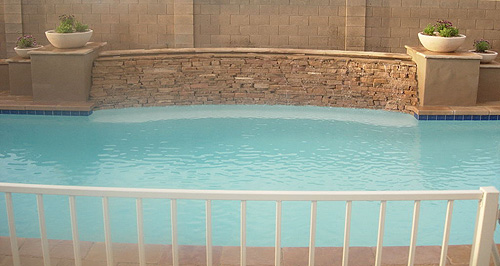 In-ground Swimming pool with Cascading Waterfall made of stone or flagstone